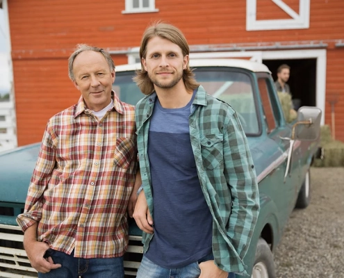 Farmer and Son Case Study two men leaning against a vintage ford truck